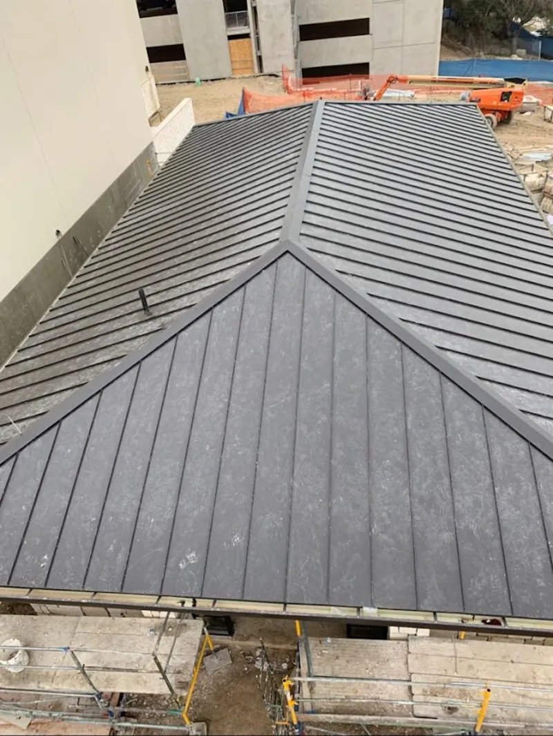 Commercial metal roof construction with crane equipment in Trenton